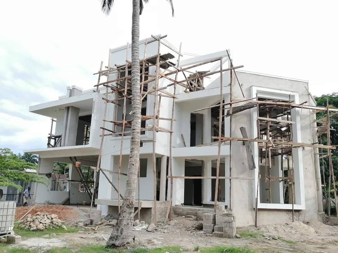 Multi-story residential building under construction with scaffolding
